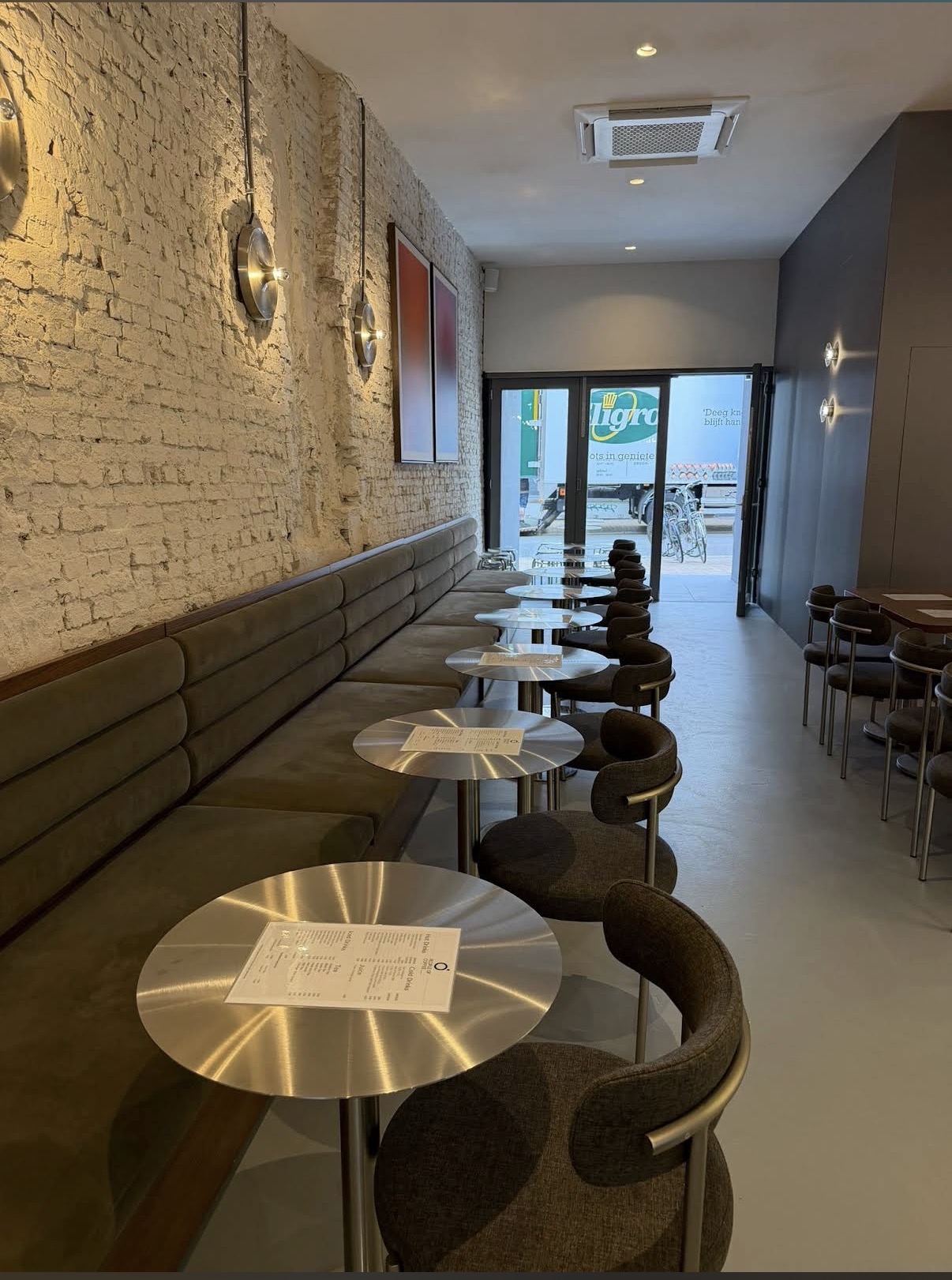 Banquette and brick interior of People of Coffee